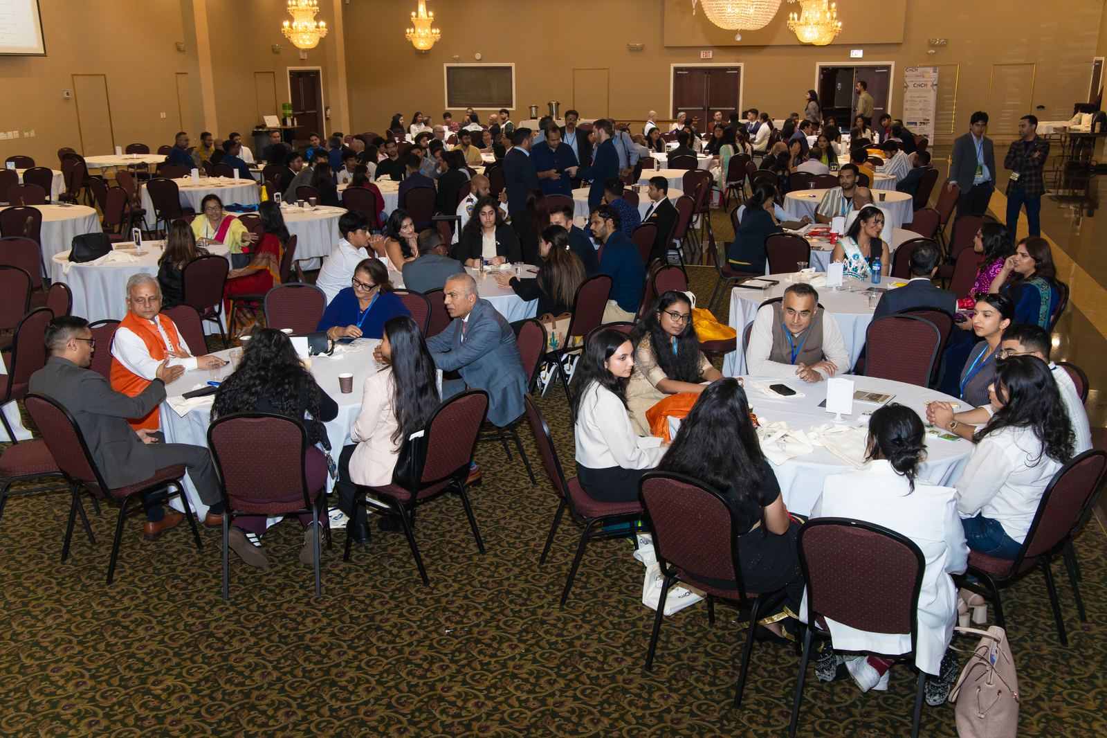 A packed ballroom of DharmaCon 2025 attendees