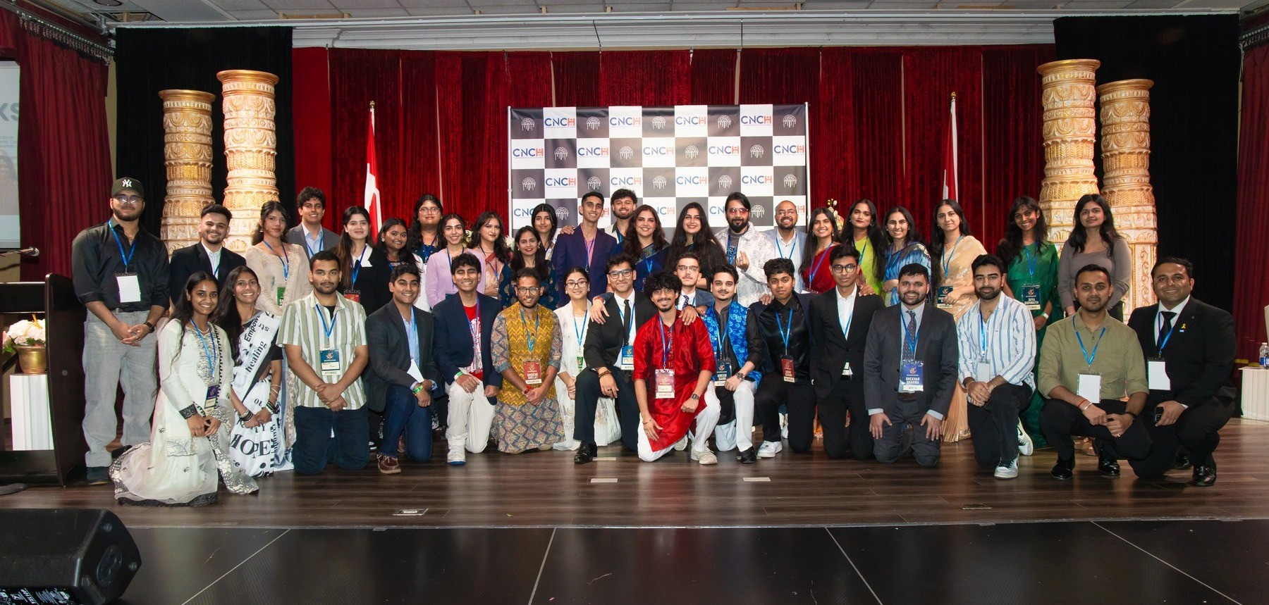 DharmaCon 2026 group photo on stage